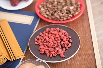 A plate of red goji berries and other Chinese medicinal materials