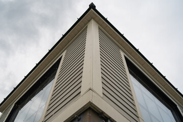 Corner building with windows in cloudy day