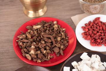 Chinese medicine Danshen on the plate and other Chinese medicine
