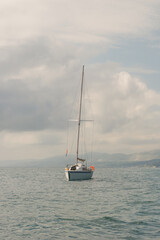 Fototapeta premium A small modern yacht without a sail in the open sea.