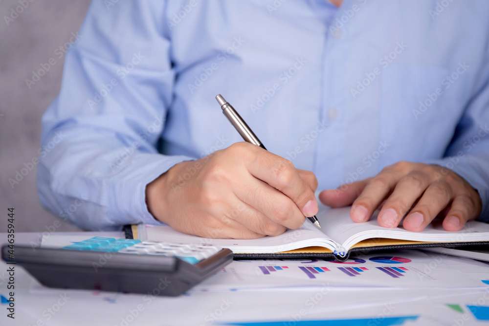 Poster hands of businessman calculate tax with calculator while laptop computer on desk, man planning finan