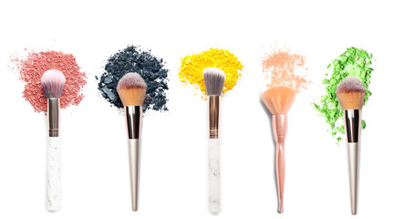 Makeup brushes with crushed eyeshadows on white background