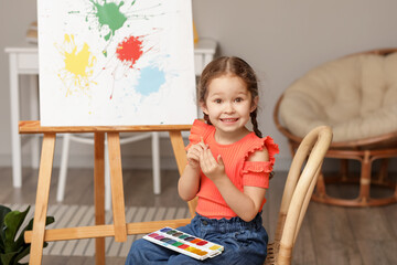 Cute little artist painting at home