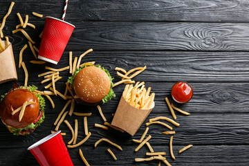 Composition with tasty french fries on dark wooden background
