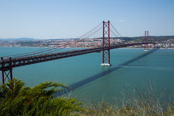 Panoramic view of 25 de Abril Bridge - suspension bridge across Tagus river connecting Lisbon city to municipality of Almada, Portugal