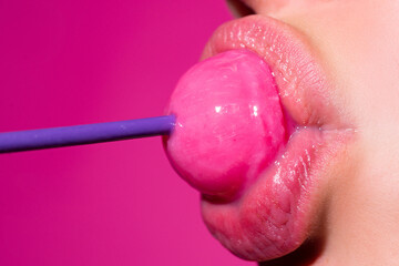 Sexy blow jobs symbol. Girl with sexy mouth eating chupa chups close up. Woman lips sucking...