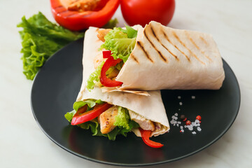 Plate with tasty doner kebabs on light background, closeup
