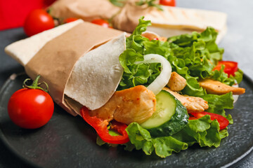 Plate with tasty doner kebab on table, closeup