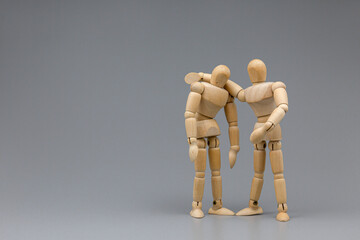 Wooden figure businessman soothe with team