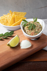 Mexican food guacamole with nacho in a bowls.