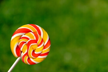 Colorful rainbow lollipop and nature background