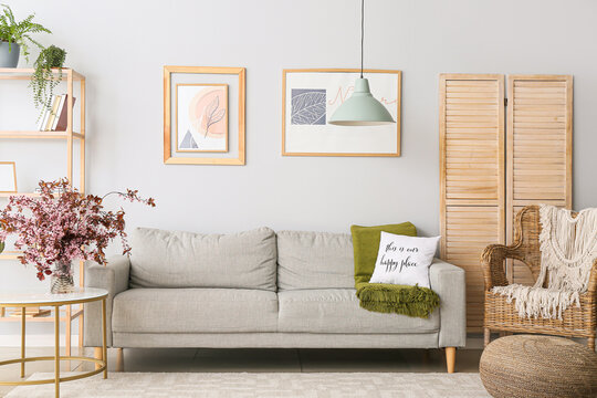 Interior of living room with vase and blossoming branches