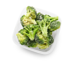 Container with frozen broccoli on white background