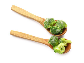 Spoons with frozen broccoli on white background