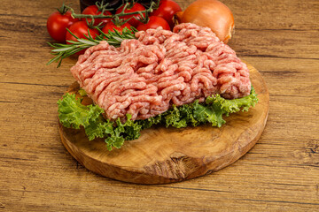 Raw pork minced meat over board
