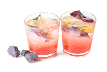 Glasses of tasty lemonade with basil on white background