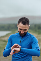 Handsome bearded man checking up his smart watch