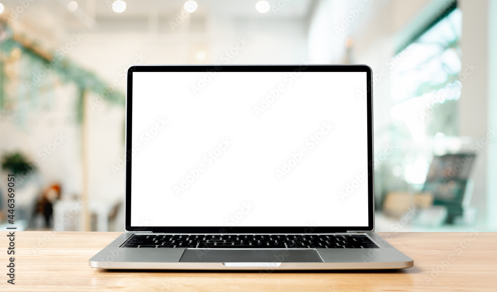 Fototapete laptop blank screen on wood table with blurred coffee shop cafe interior background and lighting bok