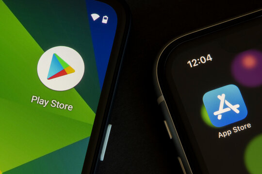 Portland, OR, USA - Apr 21, 2021: Google Play Store and Apple App Store icons are seen respectively on a Google Pixel smartphone and an iPhone.