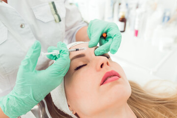 Beautiful woman gets botox injection in her face