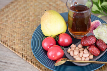 A cup of brewed black tea in the snack fruit plate