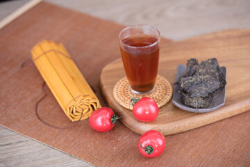Black tea and bamboo slips and a few cherry tomatoes