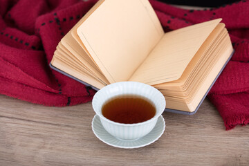 A bowl of tea beside the open blank book