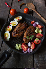 Chicken steak and vegetables in a pan with use of selective focus