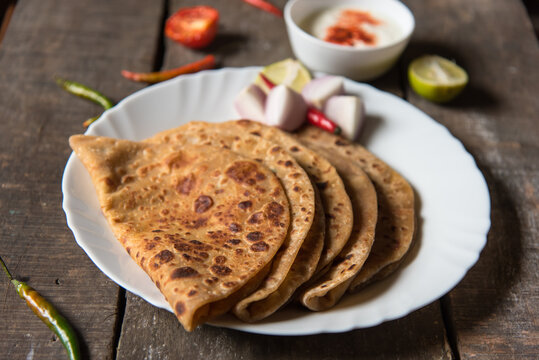 Stuffed dal paratha or sattu paratha with curd. A famous north Indian breakfast menu.