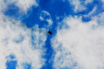Japan Air Self Defense Force aerobatic team Blue Impulse flying in deep blue sky