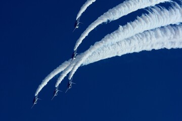 Japan Air Self Defense Force aerobatic team Blue Impulse flying in deep blue sky