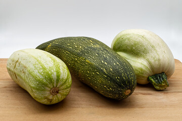 Fresh raw zucchini isolated on wooden background
