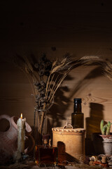 Still life in the genre of Fantasy. Potion bottles, candle, medicine, broken amphora. Ingredients for making the potion.