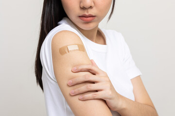Young beautiful asian woman feel pain in arm after receiving the vaccine. She was worried and...