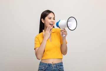 Shout out loud with megaphone. Young beautiful asian woman woman announces with a voice about...