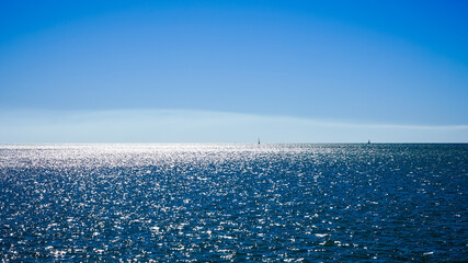 sea and sky with sailing boats on the horizon 