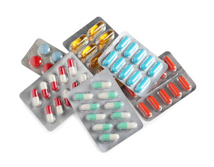 Blisters with different pills on white background, top view