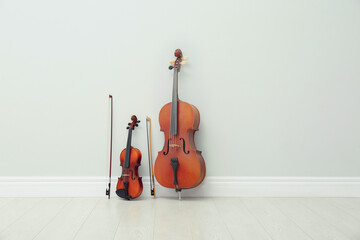 Stringed musical instruments near white wall indoors