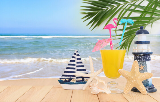 image of tropical and exotic fruit coctail over wooden table infront of sea landscape background