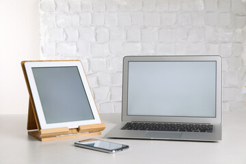 Modern laptop, tablet and smartphone on table indoors. Space for design
