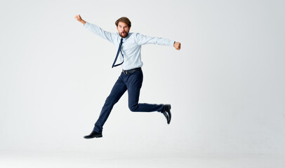 Fototapeta na wymiar man in suit emotions office jump light background
