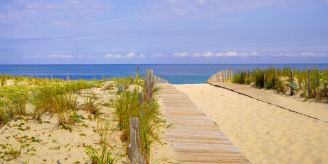 Fototapeta na wymiar dunes sea access on bright summer day view header panoramic in Cap-Ferret ocean atlantic beach