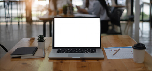 Mockup image of a laptop computer with white blank screen on wooden desk.