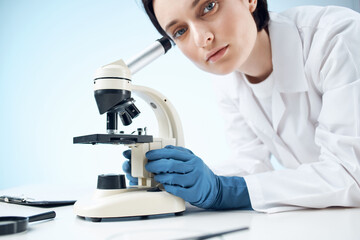 female doctor laboratory science research microscope