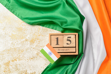 Indian flags and calendar with date 15 August on light background. Independence Day celebration