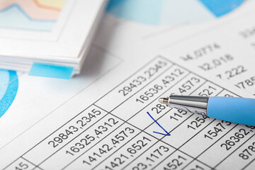 Accounting document with pen,color diagram and checking financial chart. Concept of banking, financial report and financial audit. In blue color.