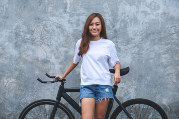 Portrait image of a beautiful young asian woman wearing white t-shirt and jean short pant with...