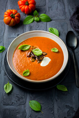 Homemade tomato soup with roasted eggplant and basil