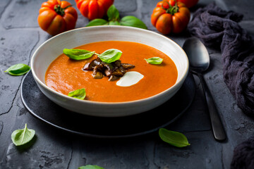 Homemade tomato soup with roasted eggplant and basil