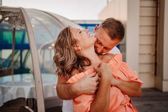 a man and a woman in love dance to a rooftop cafe on a date.